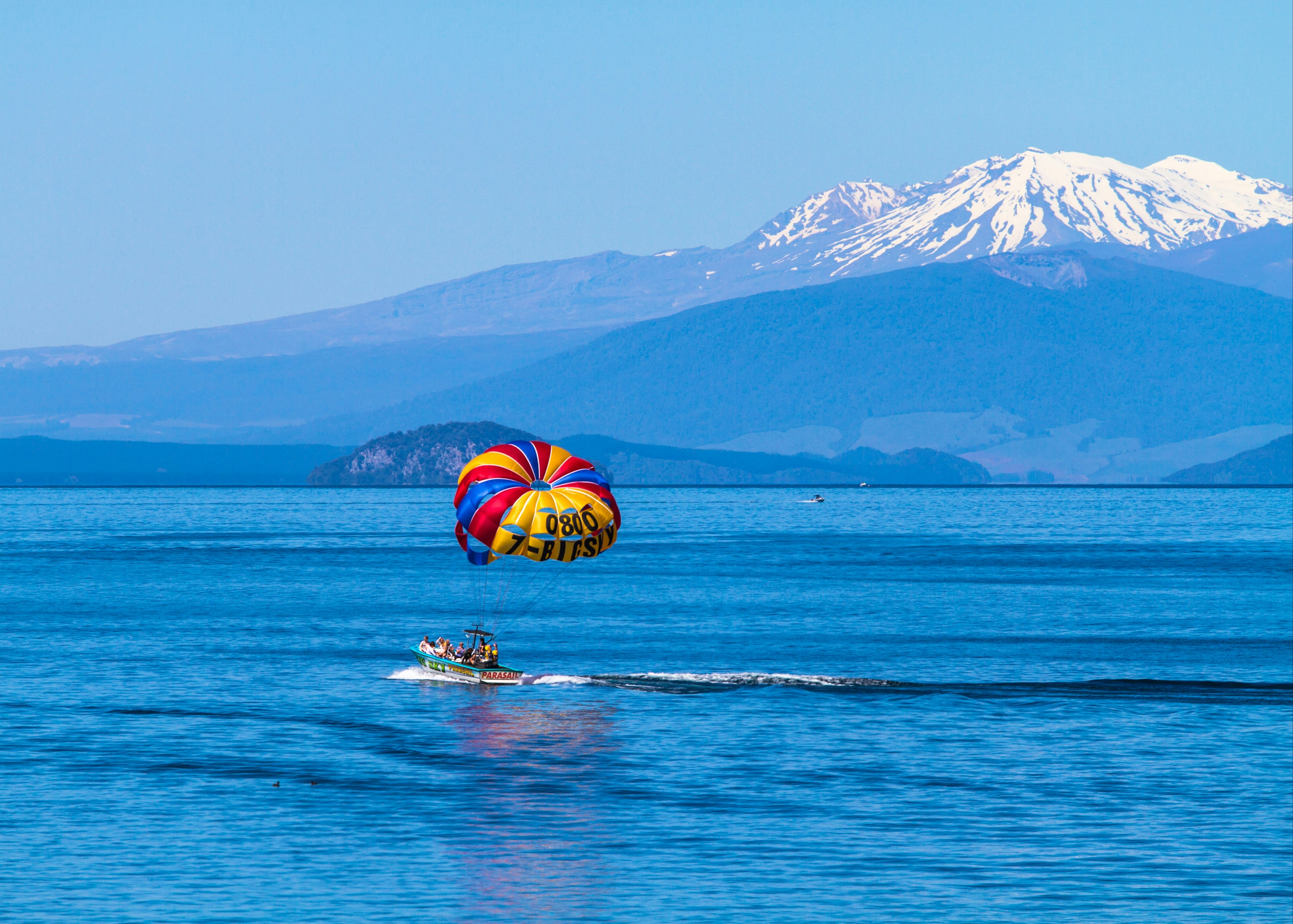 person riding a boat under blue sky